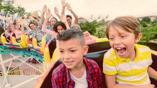 child riding roller coaster